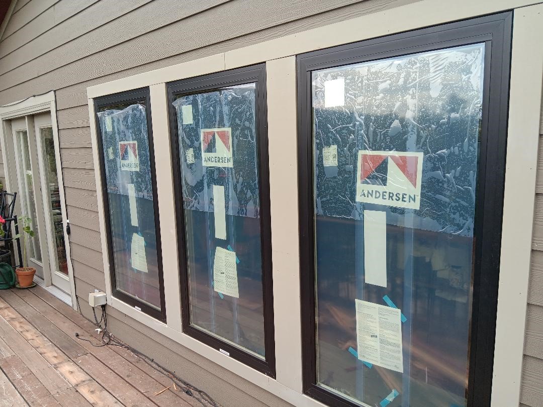 Evergreen, CO. Andersen 100 series fibrex picture windows color Black The plastic over the glass is a protective film removed after install
