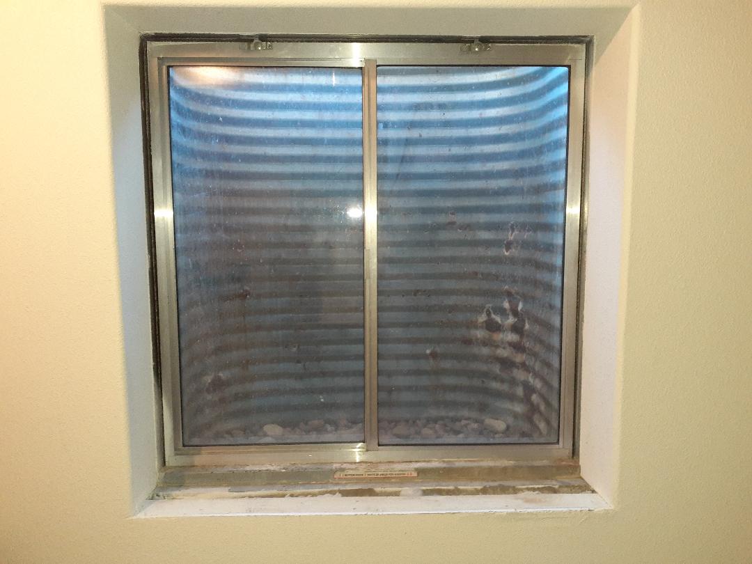 Lakewood, CO. Old aluminum basement window before image